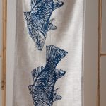 Texture of linen with hand-printed blue Australian barramundi illustration